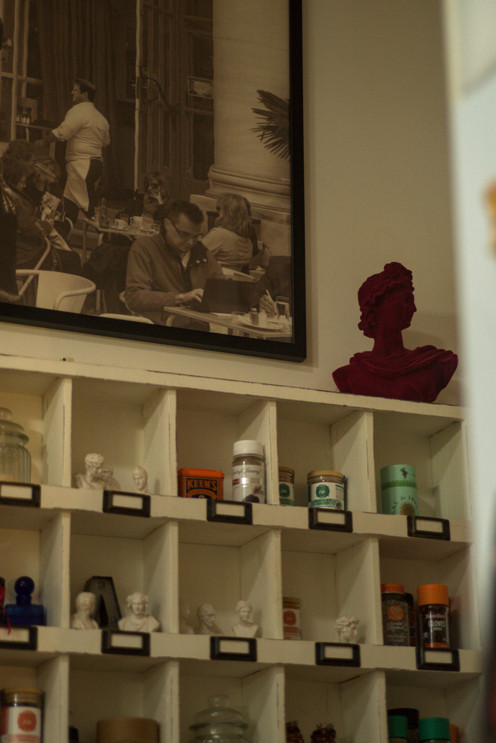 Beauty Everyday, 10: Photographic poster displayed above a spice rack in neutral interior light.